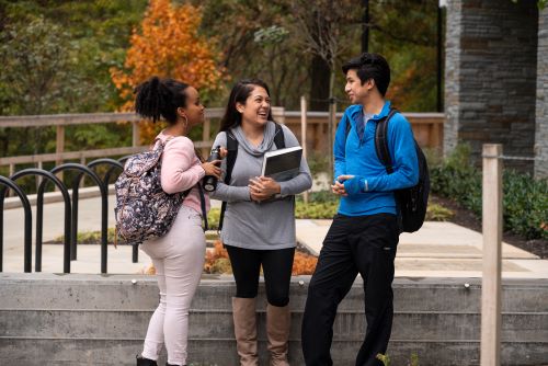 Three students laughing on the Shady Grove campus.